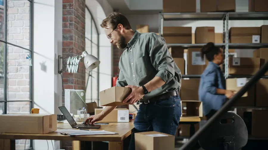 A man packing orders in a small warehouse
