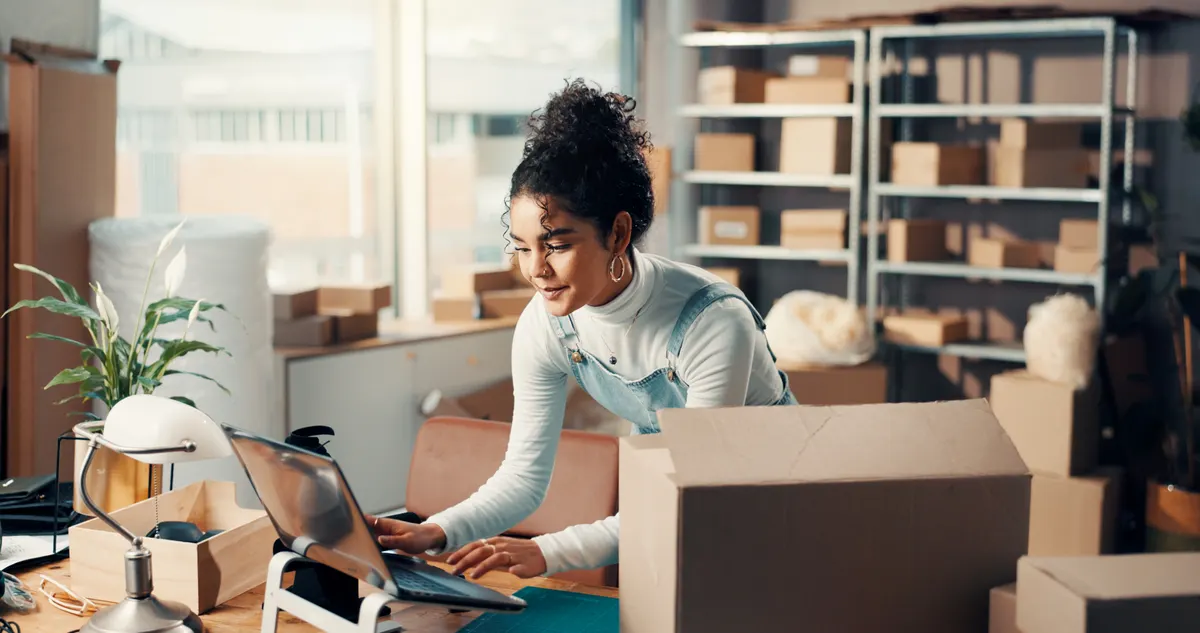Ecommerce email marketing: logistics, laptop and happy woman typing in office for ecommerce, procurement email or distribution. Computer, shipping distributor or online for order update, stock or supply chain in small business.