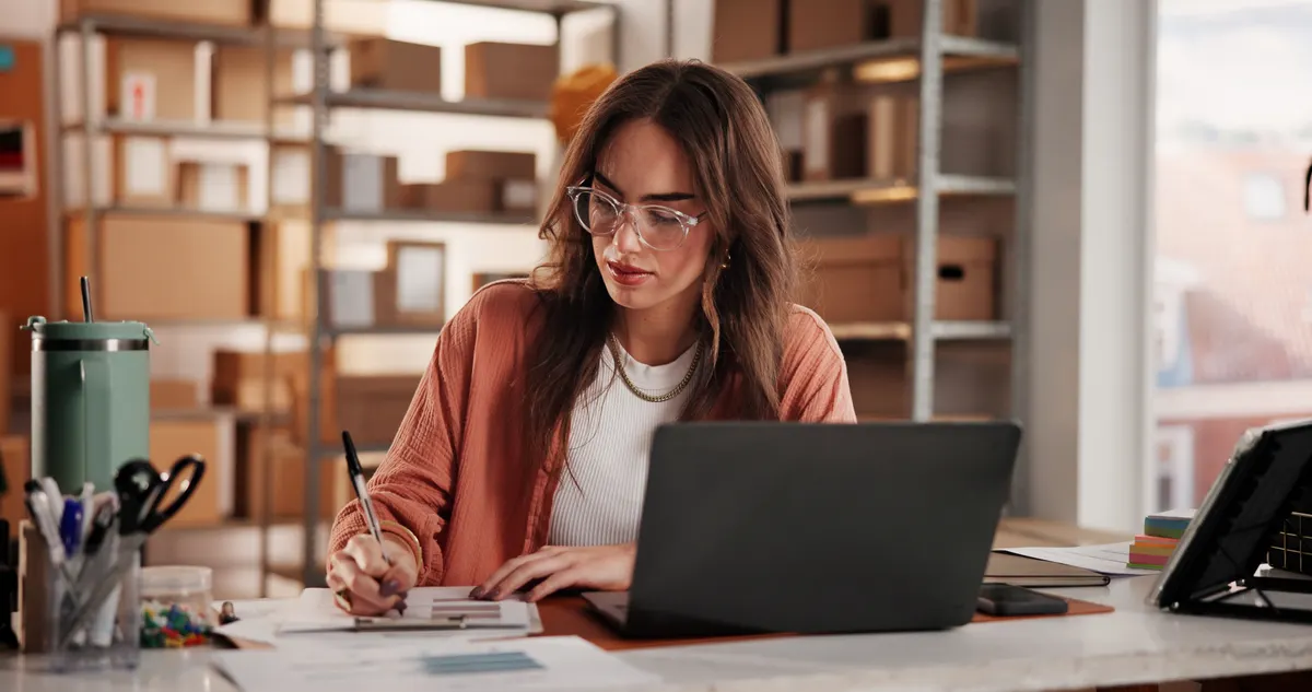 Winback campaign: supply chain, business and woman on laptop with notebook for planning, inventory and checklist. Office, retail supplier and person on computer for research, ecommerce and shipping for customer order.