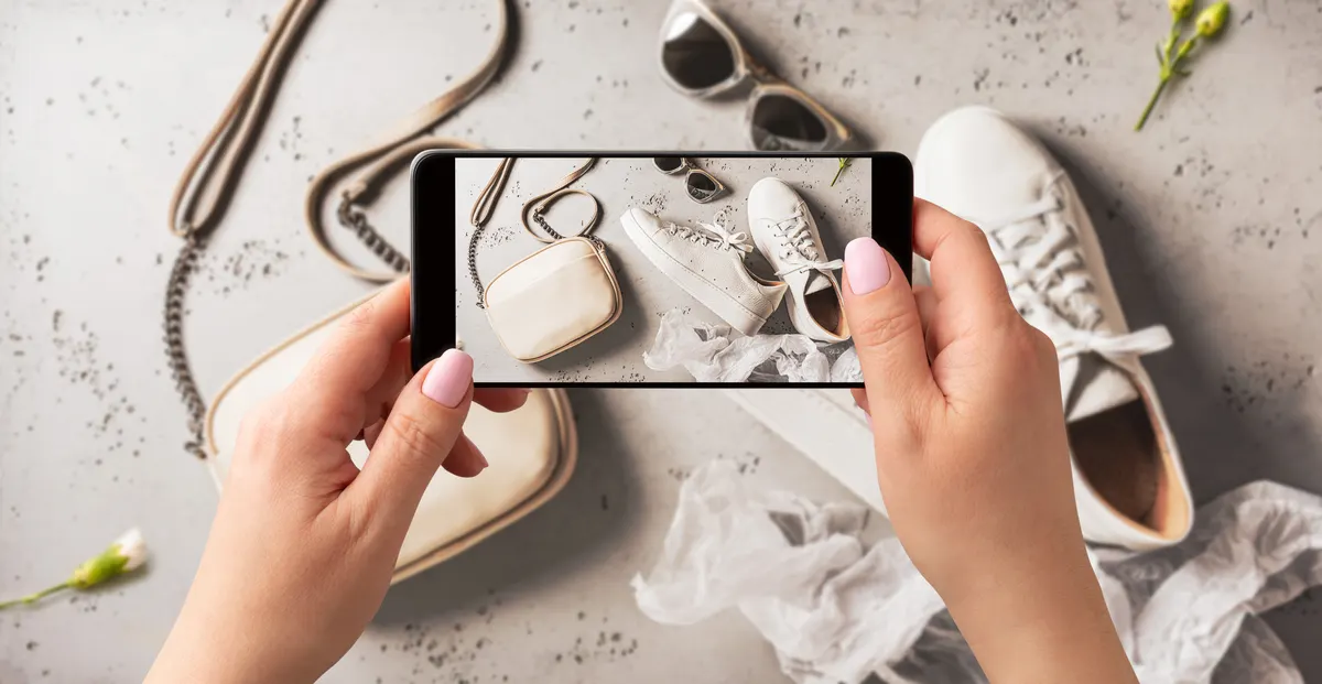 Apparel & fashion ecommerce marketing agency: woman taking photo of spring fashion accessories with smartphone. Influencer and social media.