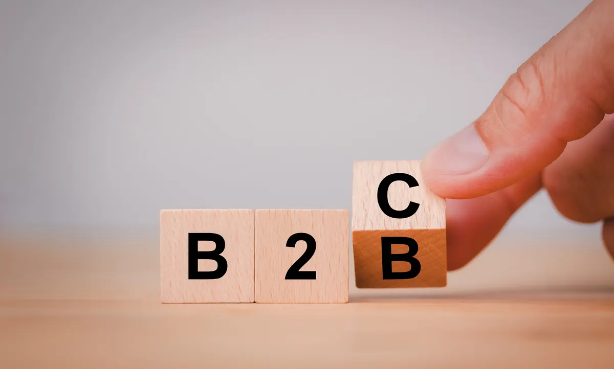 B2B ecommerce marketing agency: supply change between Business supplier and customer relations concept with Hand flipping wooden cubes block for change wording B2B to B2C.