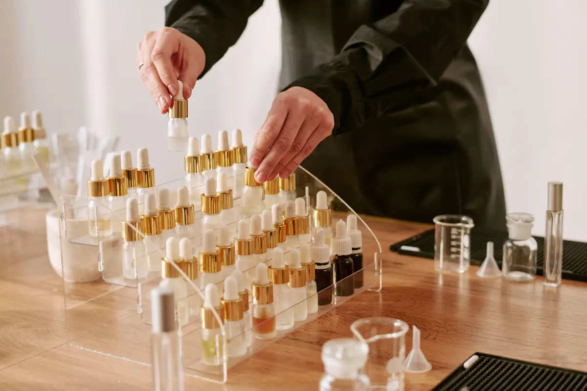 Beauty & skincare ecommerce marketing agency: woman Arranging Perfume Bottles for Product Marketing.