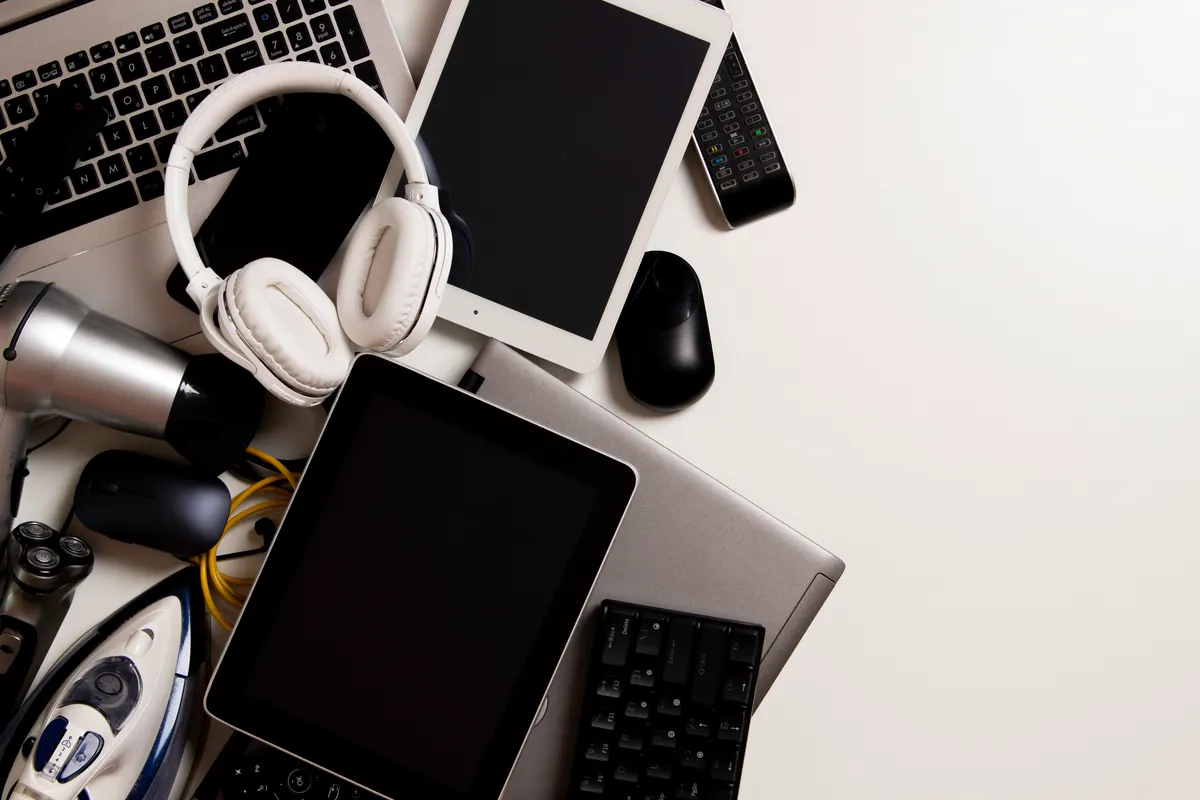 Electronics ecommerce marketing agency: old computers, digital tablets, mobile phones, many used electronic gadgets devices, broken household and appliances on white background. Planned obsolescence, electronic waste for recycling concept.