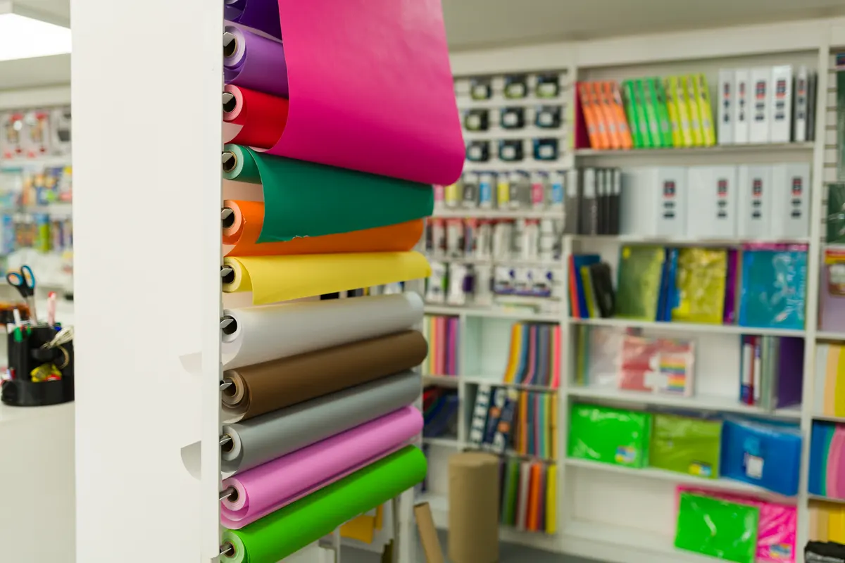 Hobby & specialty ecommerce marketing agency: colorful paper rolls and school supplies in stationery shop.