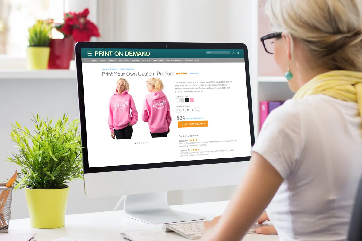 Personalized products ecommerce marketing agency: woman creating her own products by using print on demand service online.