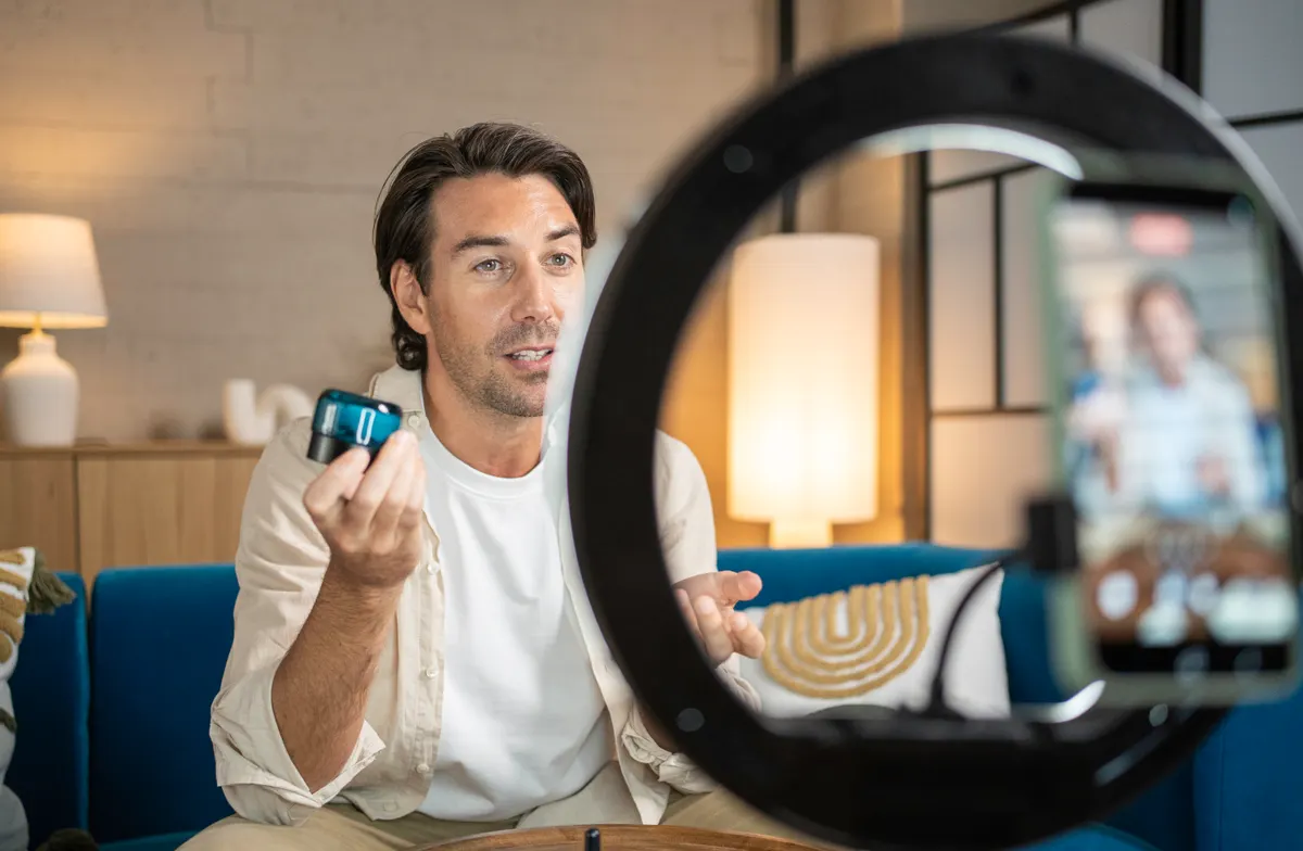 Creative fatigue: male influencer creating content reviewing skincare product.