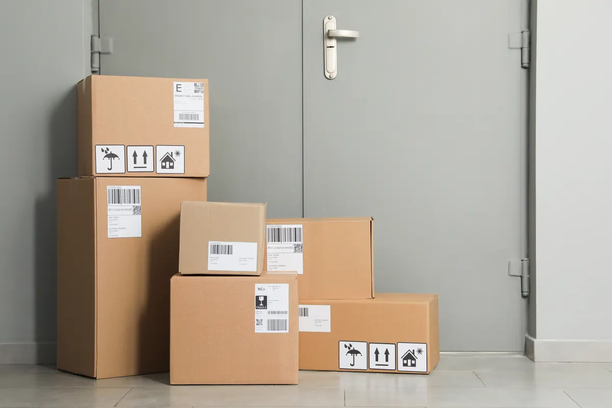 How seasonality hides revenue leaks: cardboard boxes on floor near entrance. Parcel delivery service.