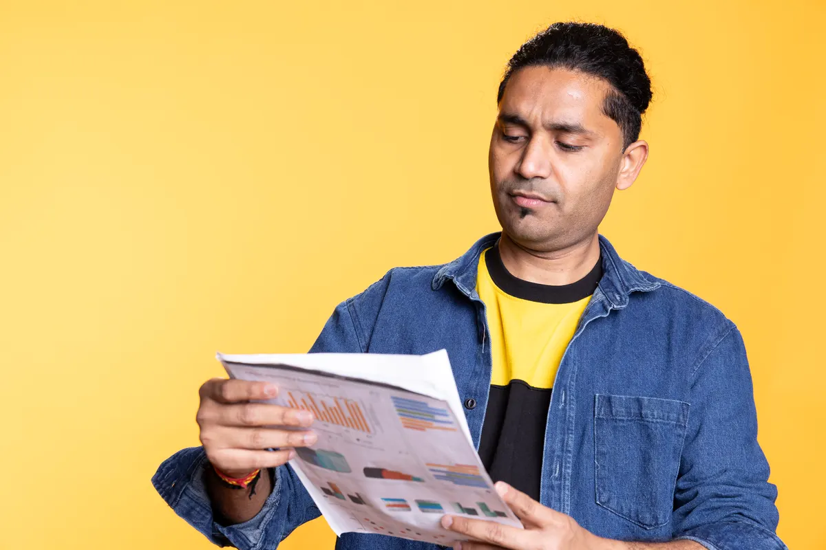 How to read our monthly report: young male manager looking over company financial profit report audit.
