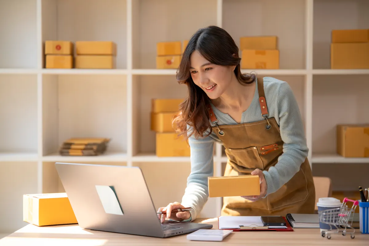 The difference between a leak and a plateau: woman preparing shipping orders for online e-commerce business.
