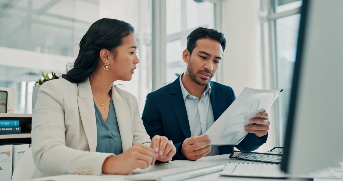 The four numbers we report every month: paperwork, meeting and business people in office for finance report, budget review and planning. Corporate, teamwork and man and woman with documents, financial proposal and investment portfolio.