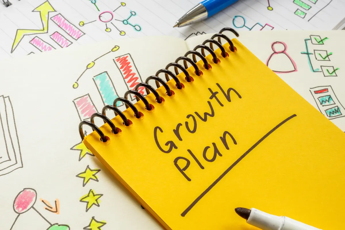 What the free growth plan is and isn't: growth plan concept. Business notes and an open notebook with writing.