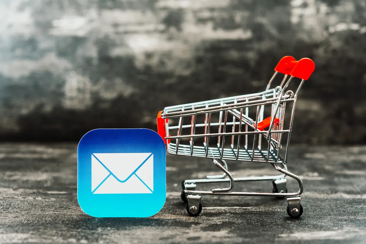 Why most abandoned cart emails are too early: business concept photo - shopping cart with Email symbol.