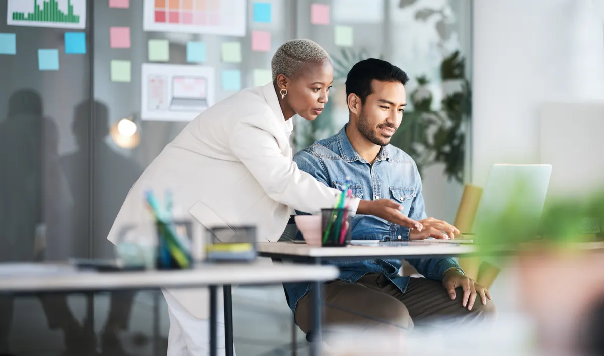 Why the author on every page is the company: office laptop, diversity and business people reading online report, website design feedback or research project. Collaboration, staff mentor and team designer working on company homepage development.