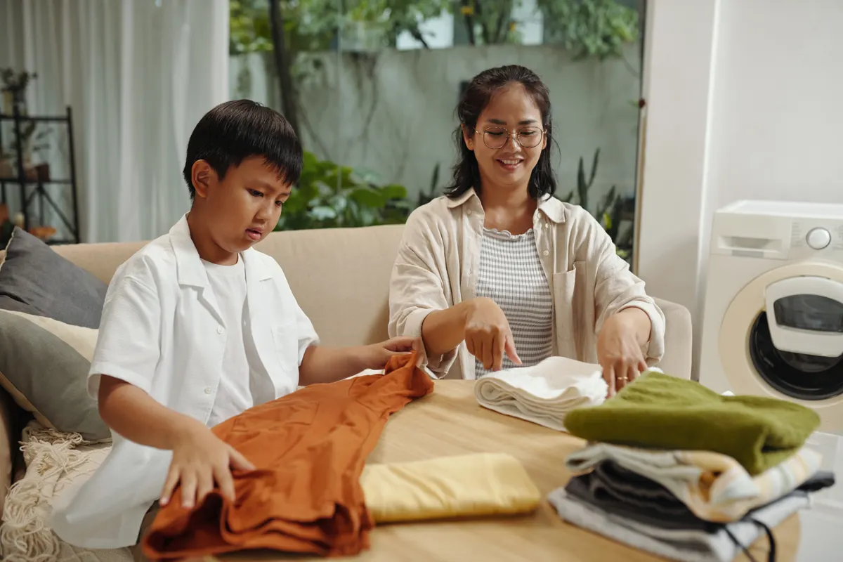 Kids' clothing marketing agency: folding and Sorting Clothes with Family in Living Room.
