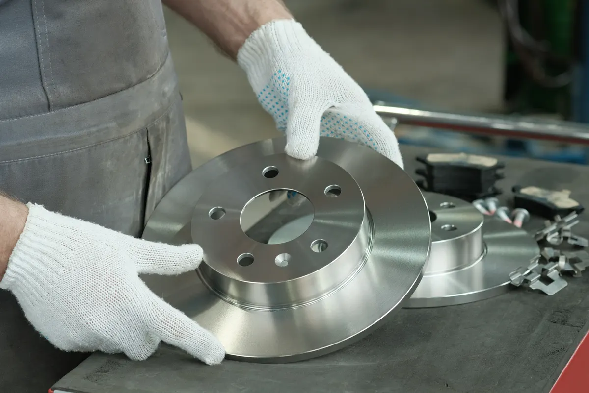 Aftermarket car part marketing agency: an auto mechanic checks the suspension elements of the car before installation.