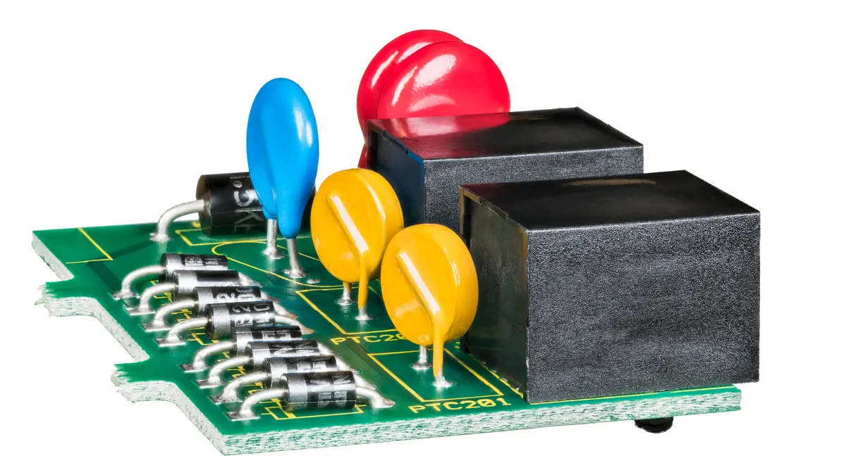 Electrical component marketing agency: electronic components on green circuit board isolated on a white background.
