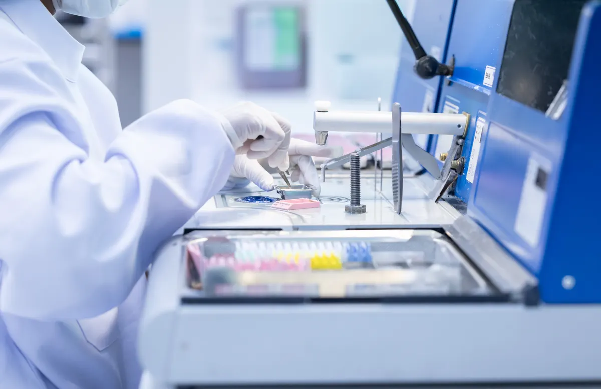 Lab equipment marketing agency: laboratory technician conducting analysis with advanced equipment in a clean room environment during work hours.
