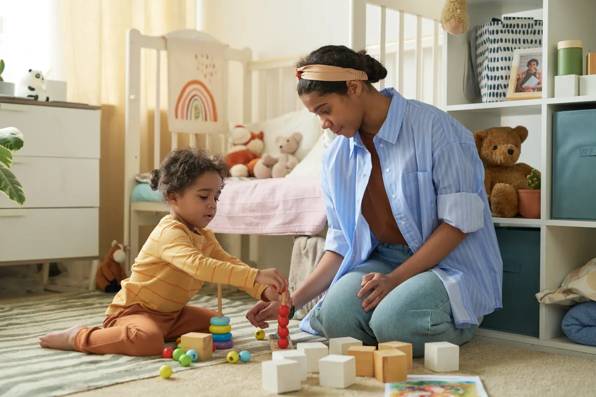 Educational toy marketing agency: mother and Child Engaging in Toy Block Playtime at Home.