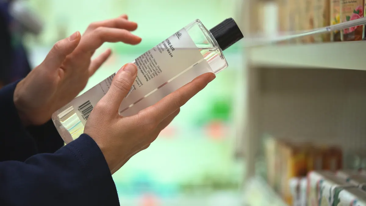 Clean beauty marketing agency: woman choosing cosmetic product in pharmacy or beauty shop.