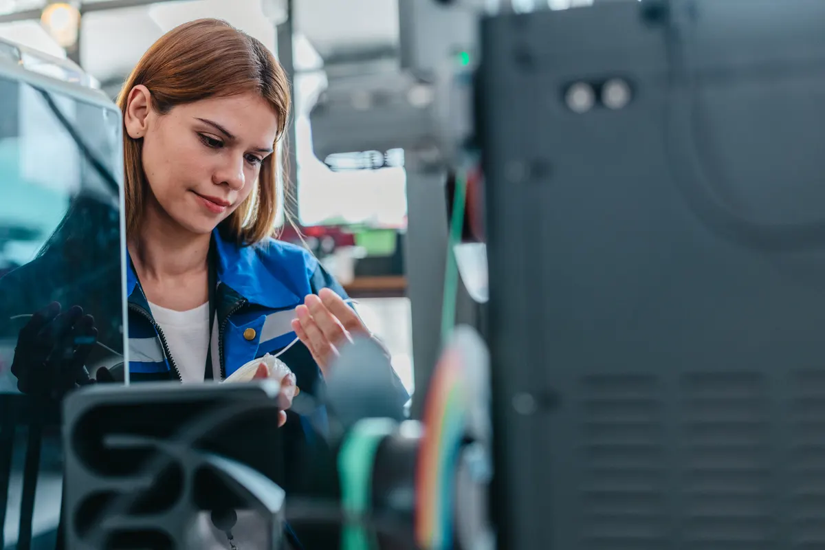3D printer marketing agency: engineer Inspecting 3D Printed Part.