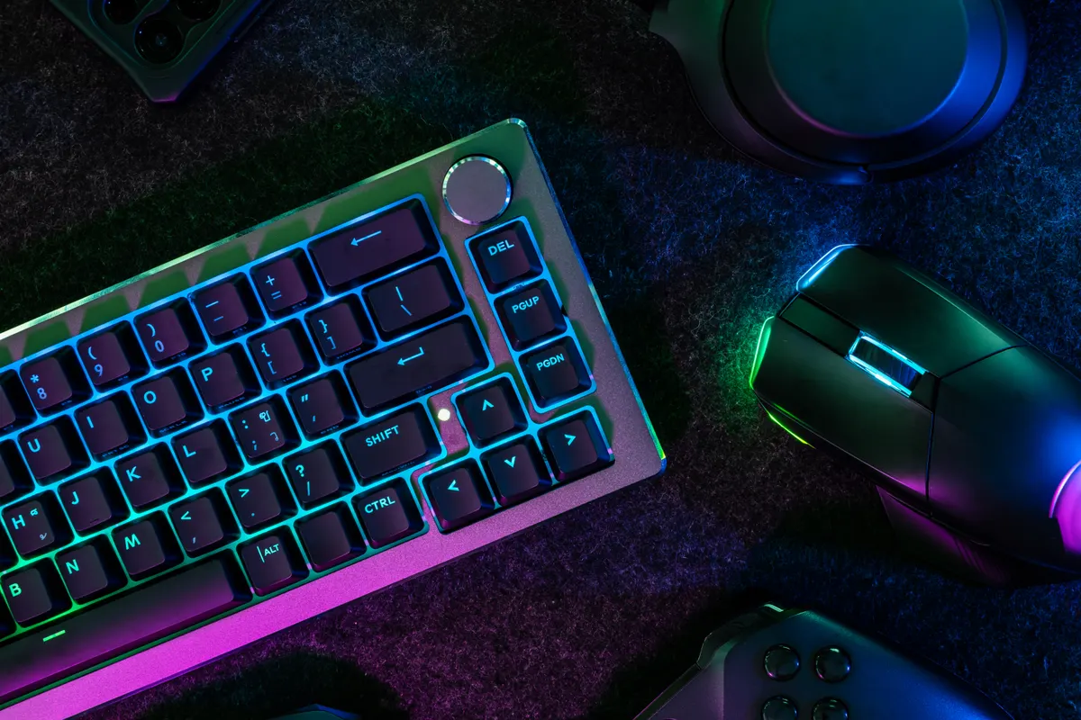 Gaming accessory marketing agency: gamer work space concept, top view a gaming gear, mouse, keyboard, joystick, headset, mobile joystick, in ear headphone and mouse pad on table background.
