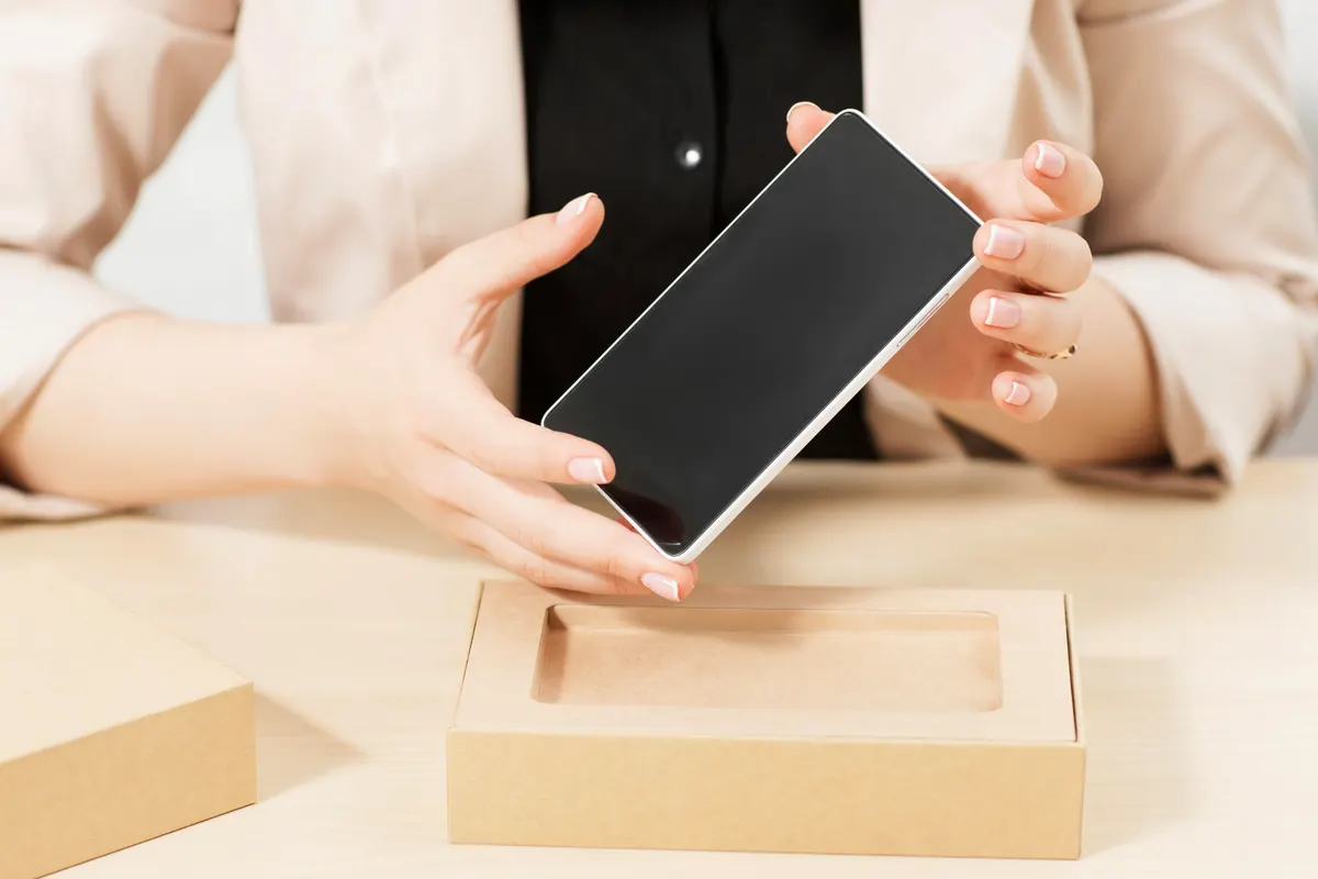 Phone accessory marketing agency: female hands holding new smartphone.