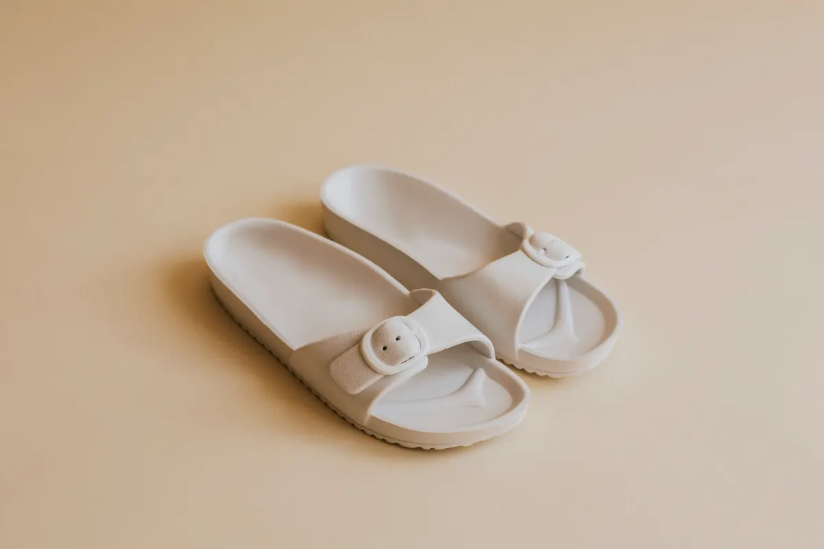 Sandal & slide marketing agency: white buckle slide sandal slippers.