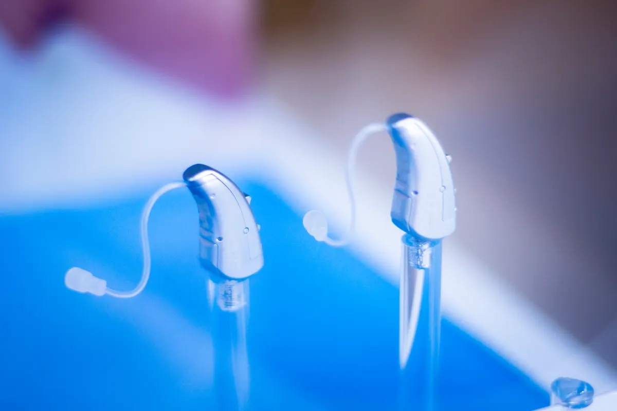 Hearing aid marketing agency: modern high technology digital hearing aids in retail store shop window for the deaf and hard of hearing.