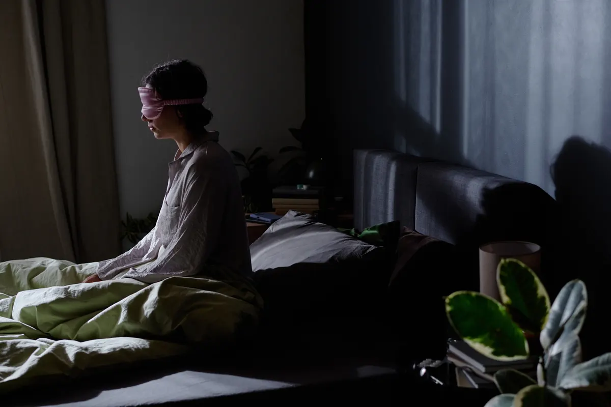 Sleep product marketing agency: woman Sitting in Bed with Pillows and Blanket.