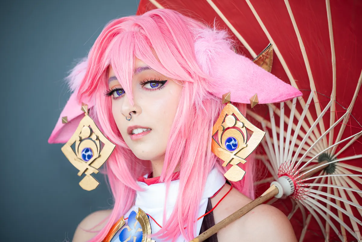 Cosplay supply marketing agency: female cosplayer in a pink anime costume wearing pink hair.
