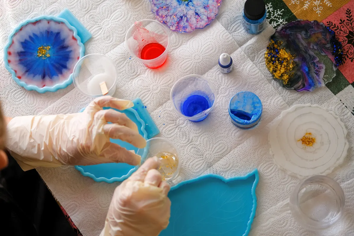 Craft supply marketing agency: woman making epoxy resin arts and crafts.