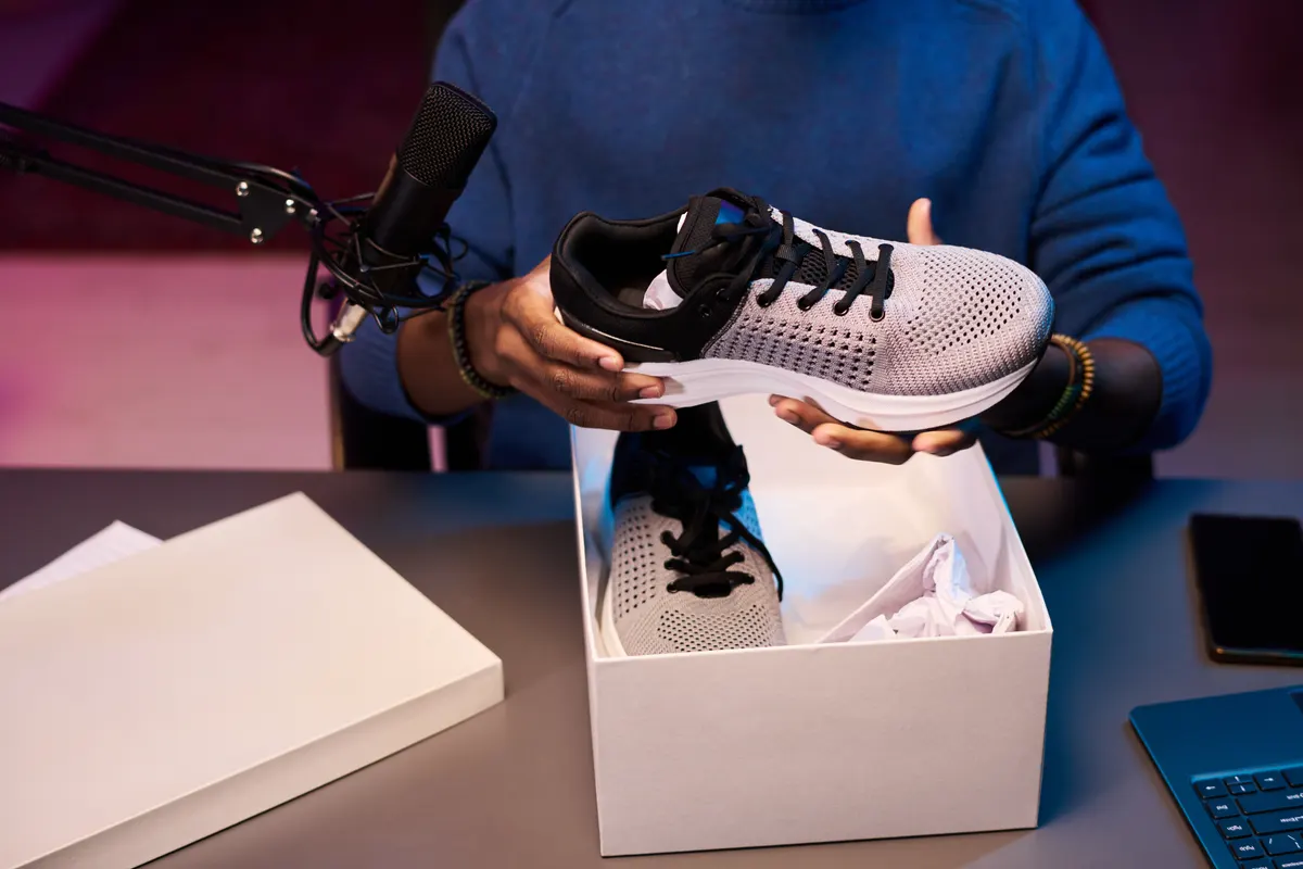 Sneaker resale marketing agency: unboxing New Sneakers During Online Review Session.