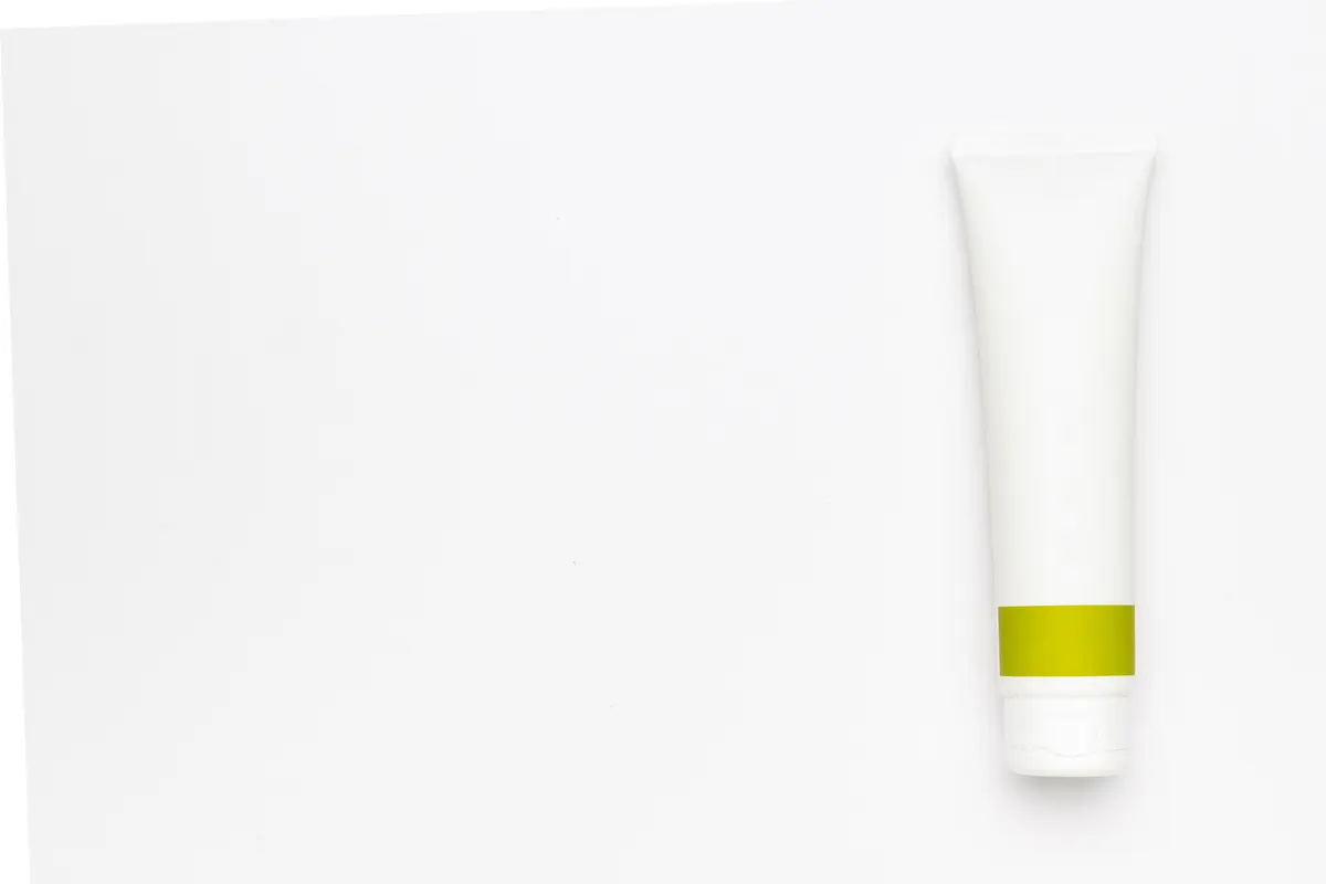 Private label brand marketing agency: minimalist White Cosmetic Tube with Green Label on Clean White Background.