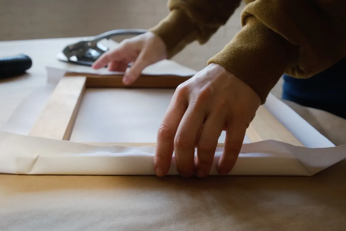 Print-on-demand art marketing agency: stretching canvas on stretcher bars. Gallery wrap. Print on canvas.