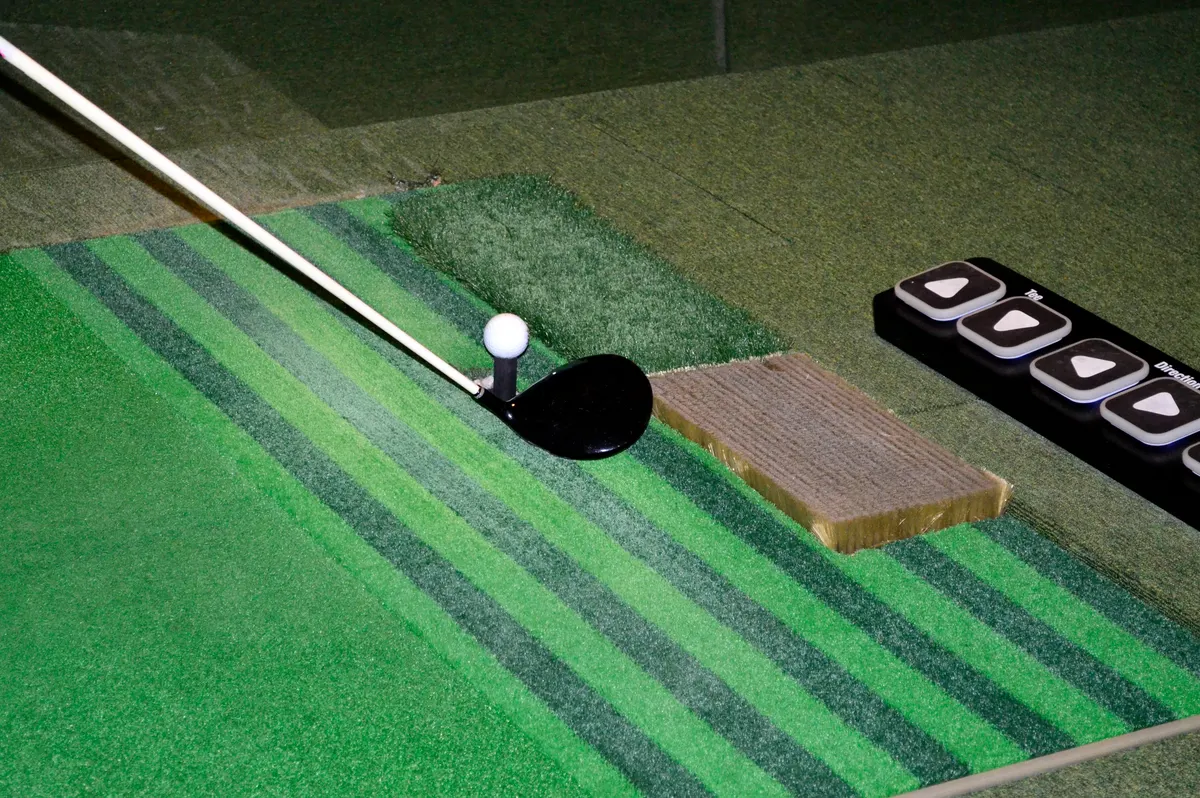 Golf equipment marketing agency: golf balls and clubs on the screen golf driving range.