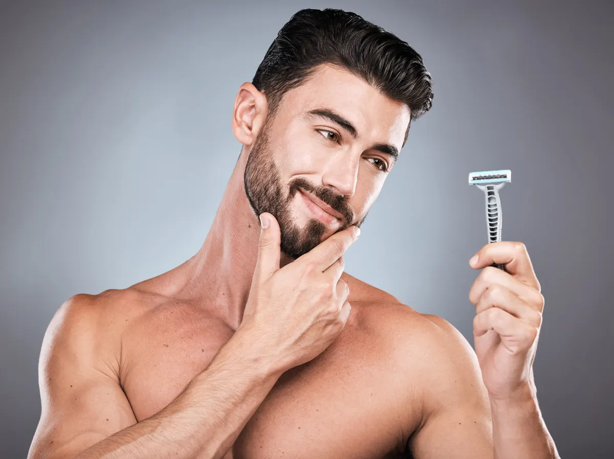 Shave subscription marketing agency: face, man thinking and razor for shaving in studio isolated on a gray background. Ideas, haircare and male model with facial tool or product to shave for wellness, health hygiene and hair removal.