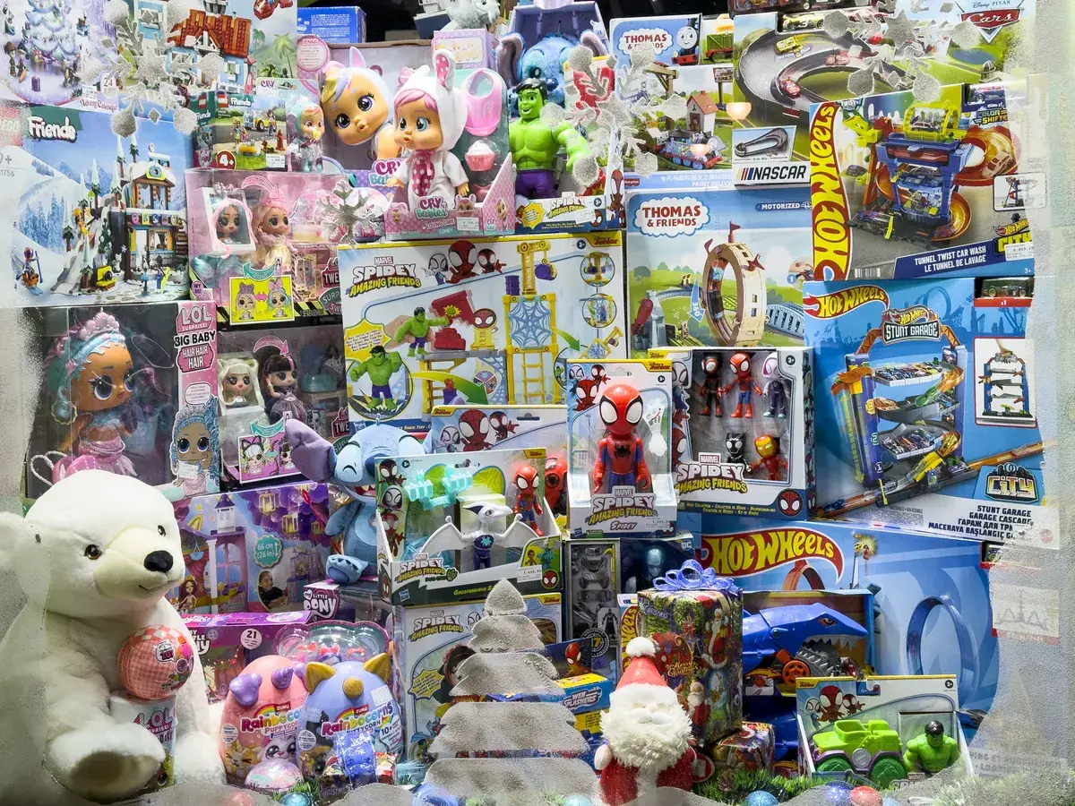Doll & action figure marketing agency: toy store window filled with Spidey merchandise, action figures, dolls, Hot Wheels sets, plush toys and boxed gifts displayed for children and shoppers in belgrade.