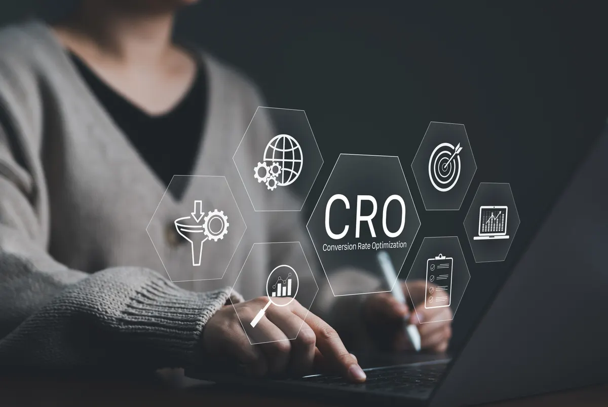 Conversion rate optimization for ecommerce: cRO, conversion rate optimization technology concept. A person works on a laptop with CRO related technology icons, symbolizing conversion rate optimization and digital marketing. business strategy,.
